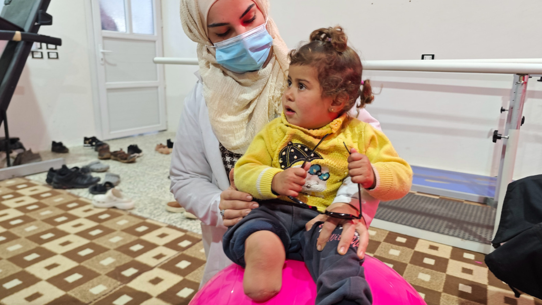 Clinician providing pediatric rehabilitation care